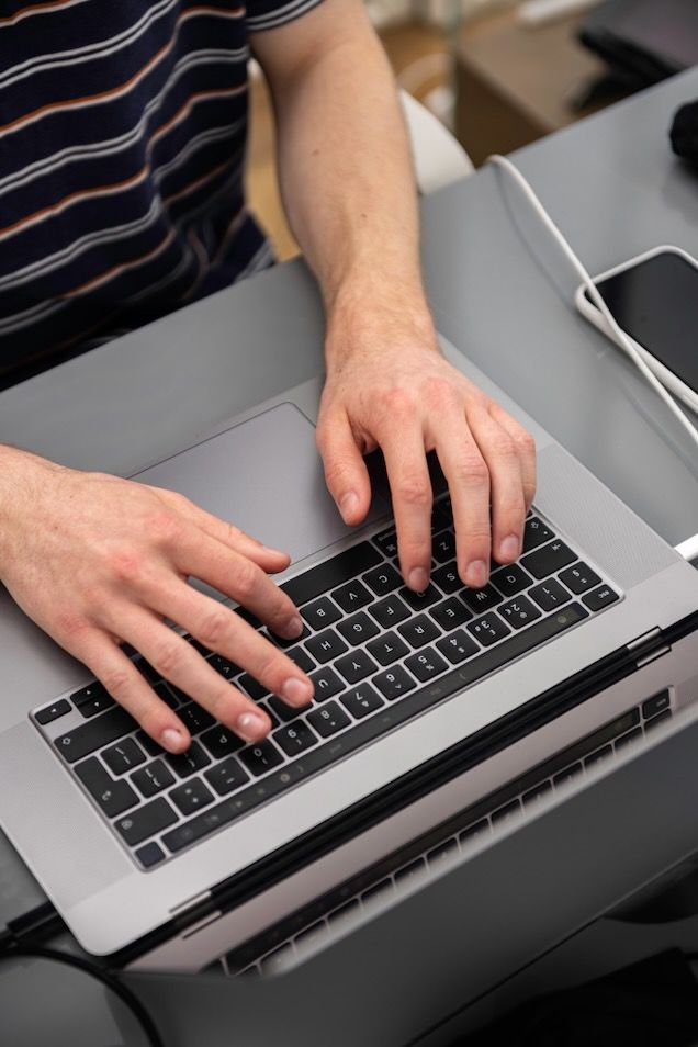 image of man typing on laptop 